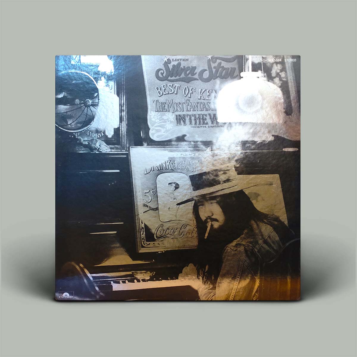 Vinyl record cover with a person wearing a hat and smoking a cigarette, surrounded by vintage-style text and images.