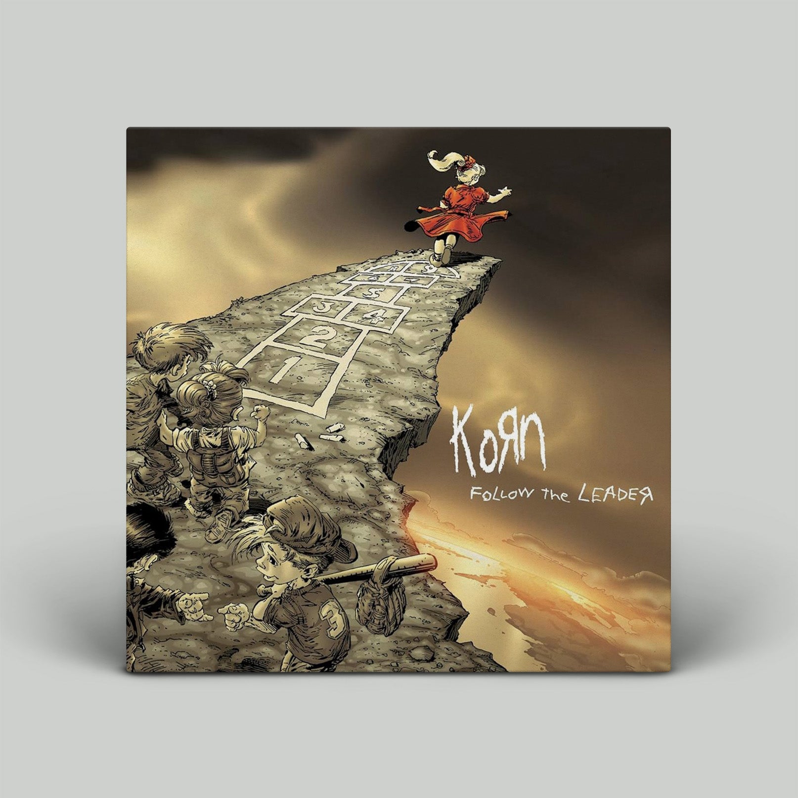 Album cover for Korn's 'Follow the Leader' with stylized illustration of a character on a cliff.