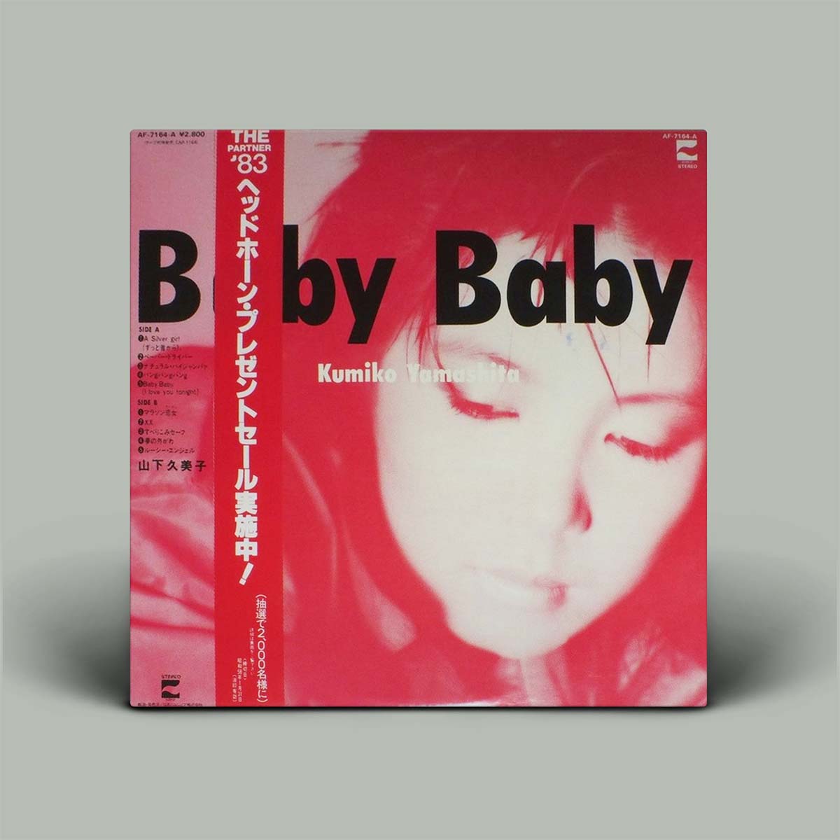 Album cover with a stylized face and text on a red background