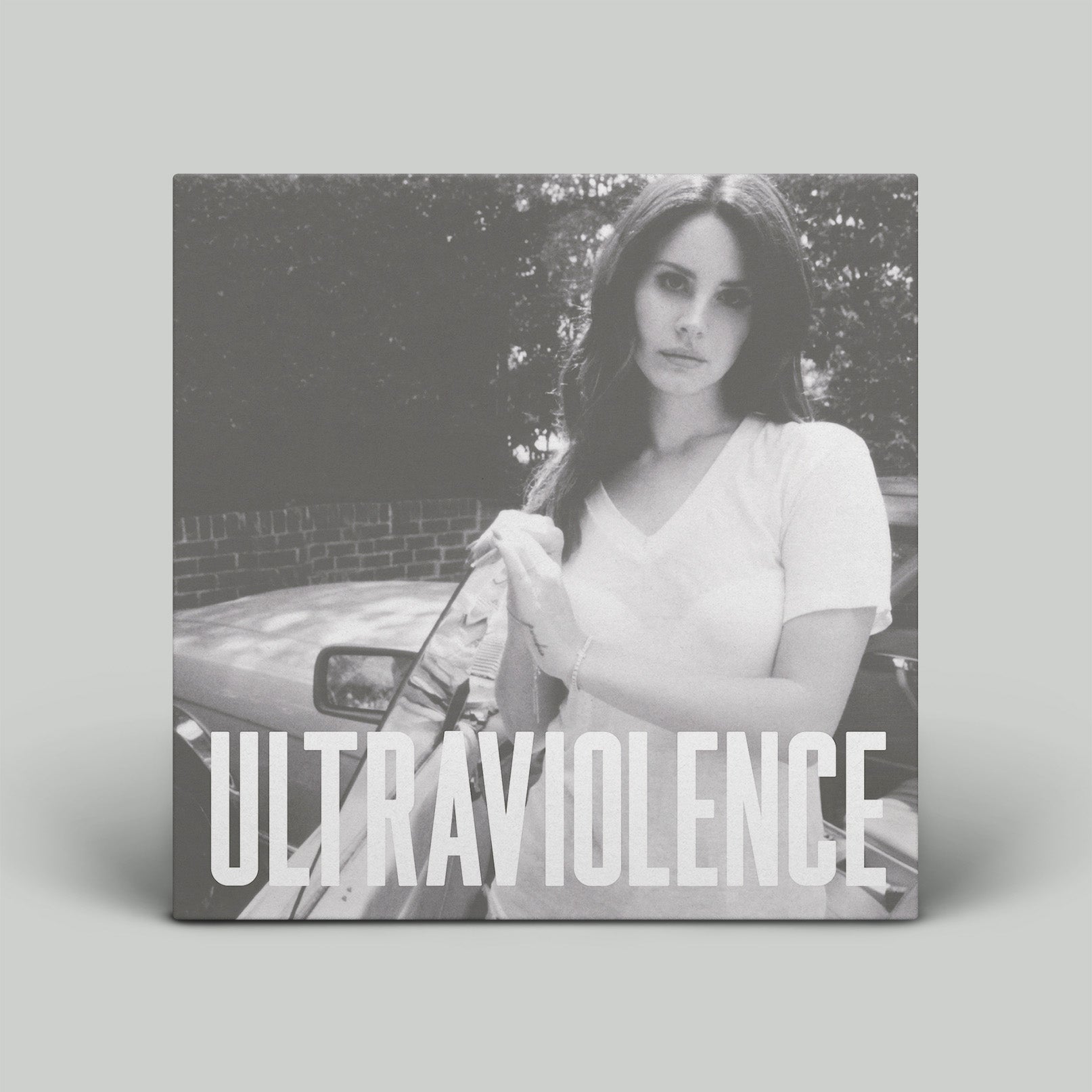 Album cover with a woman holding a gun and the title 'Ultraviolence' on a gray background