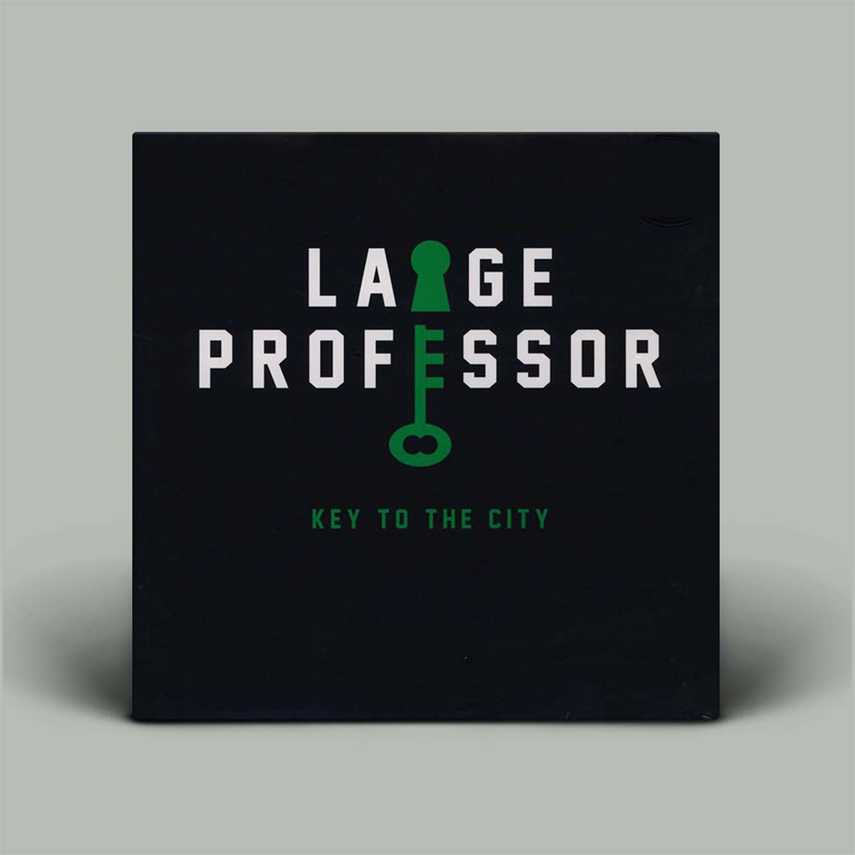 A square black album cover standing upright on a light gray background. The cover features the title 'LARGE PROFESSOR' in large white letters with a green keyhole graphic integrated into the lettering, and the subtitle 'KEY TO THE CITY' in smaller green text below.