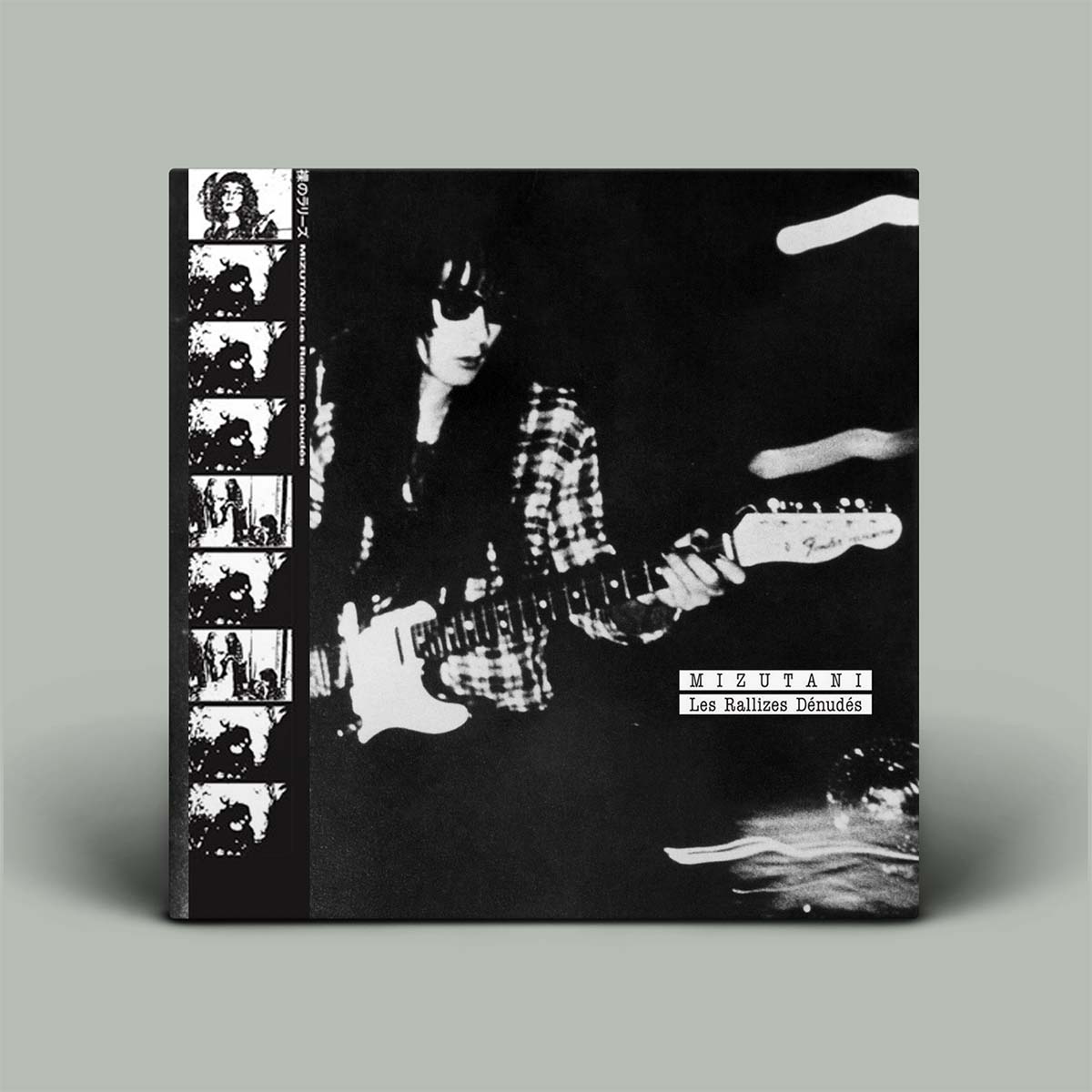 Album cover with black and white photograph of a person playing guitar, featuring the artist's name.