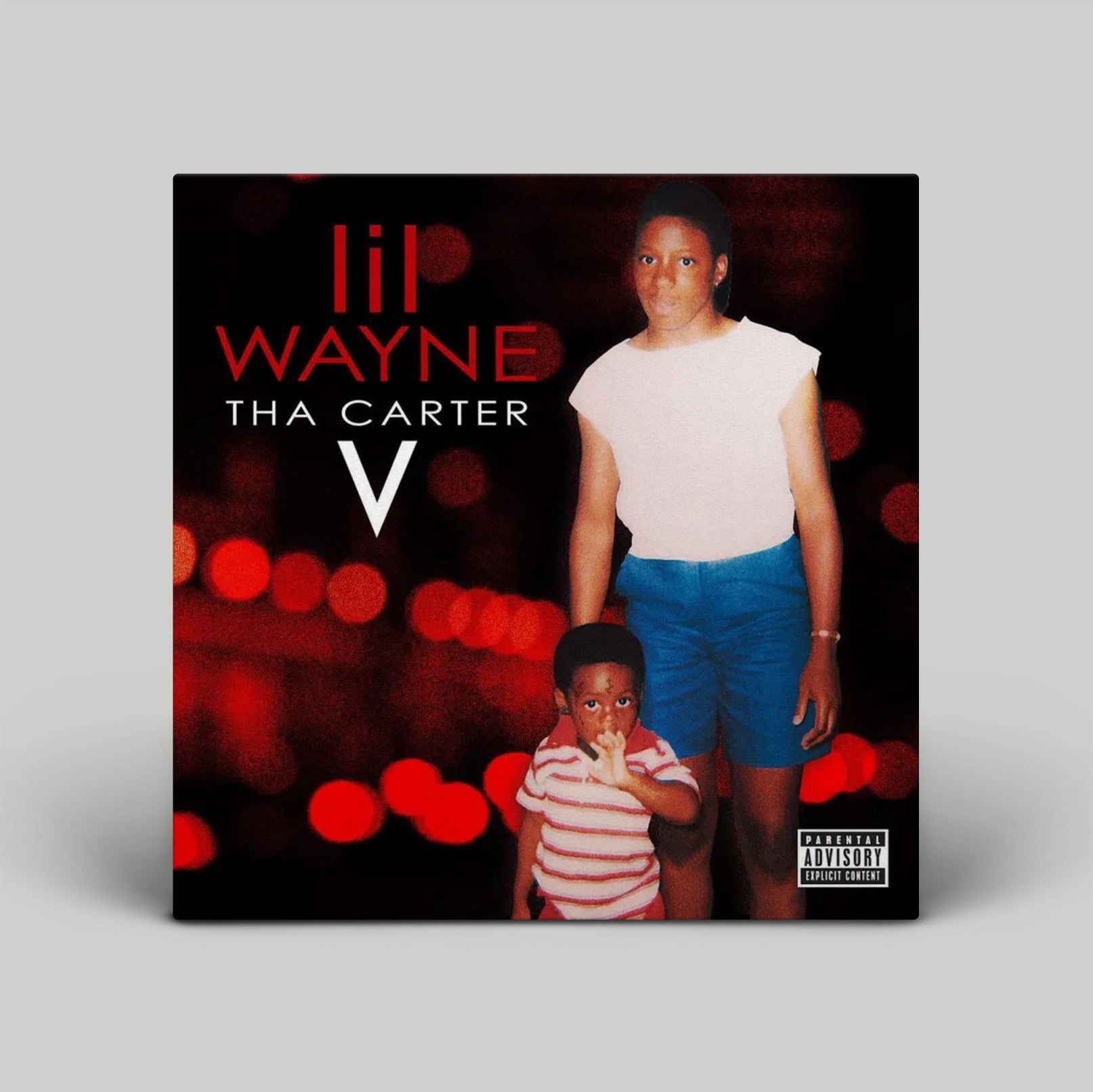 Album cover for 'Tha Carter V' by Lil Wayne with a blurred background and two people in the foreground.