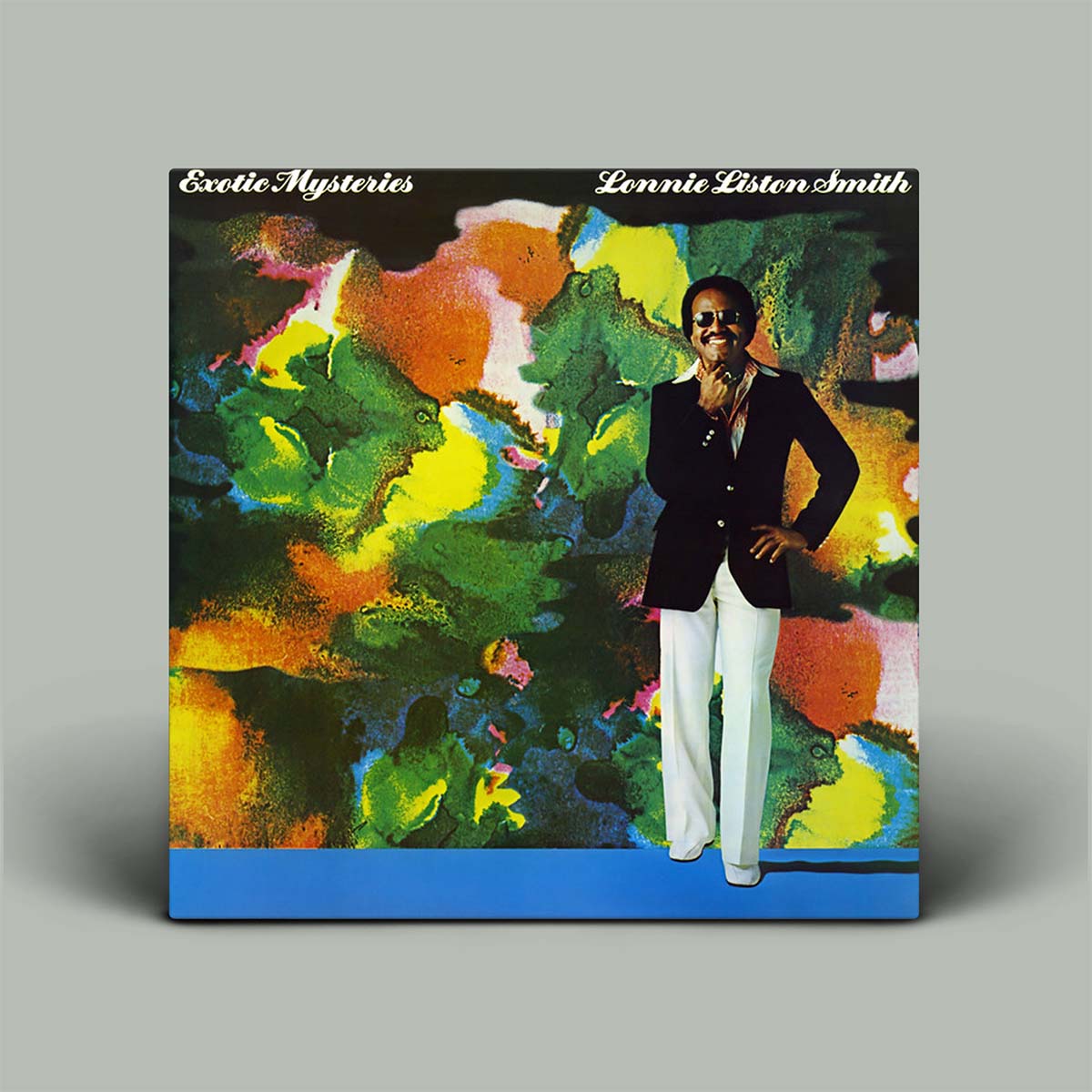 Vinyl record cover with a colorful abstract design and a person standing in front on a gray background