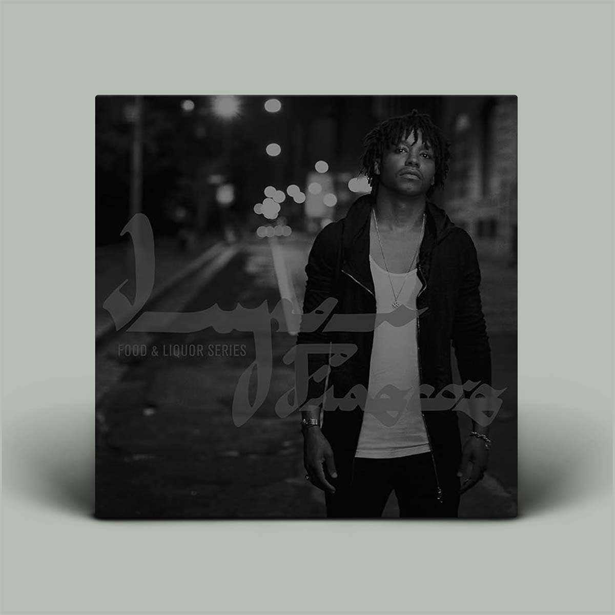 Album cover with a person standing on a street at night, featuring the album title and artist name.