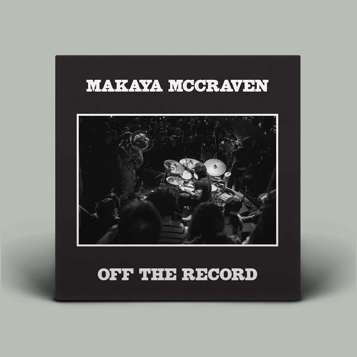 Album cover for 'Off The Record' by Makaya McCraven with a black and white photo of a drummer.