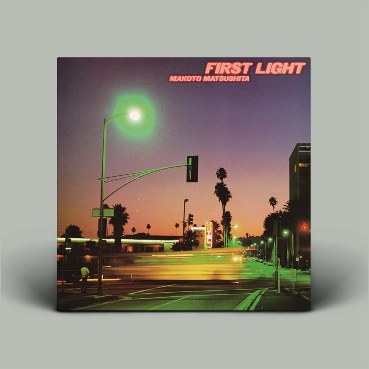 Album cover of 'First Light' by Makoto Matsushita with a city street scene at dusk.