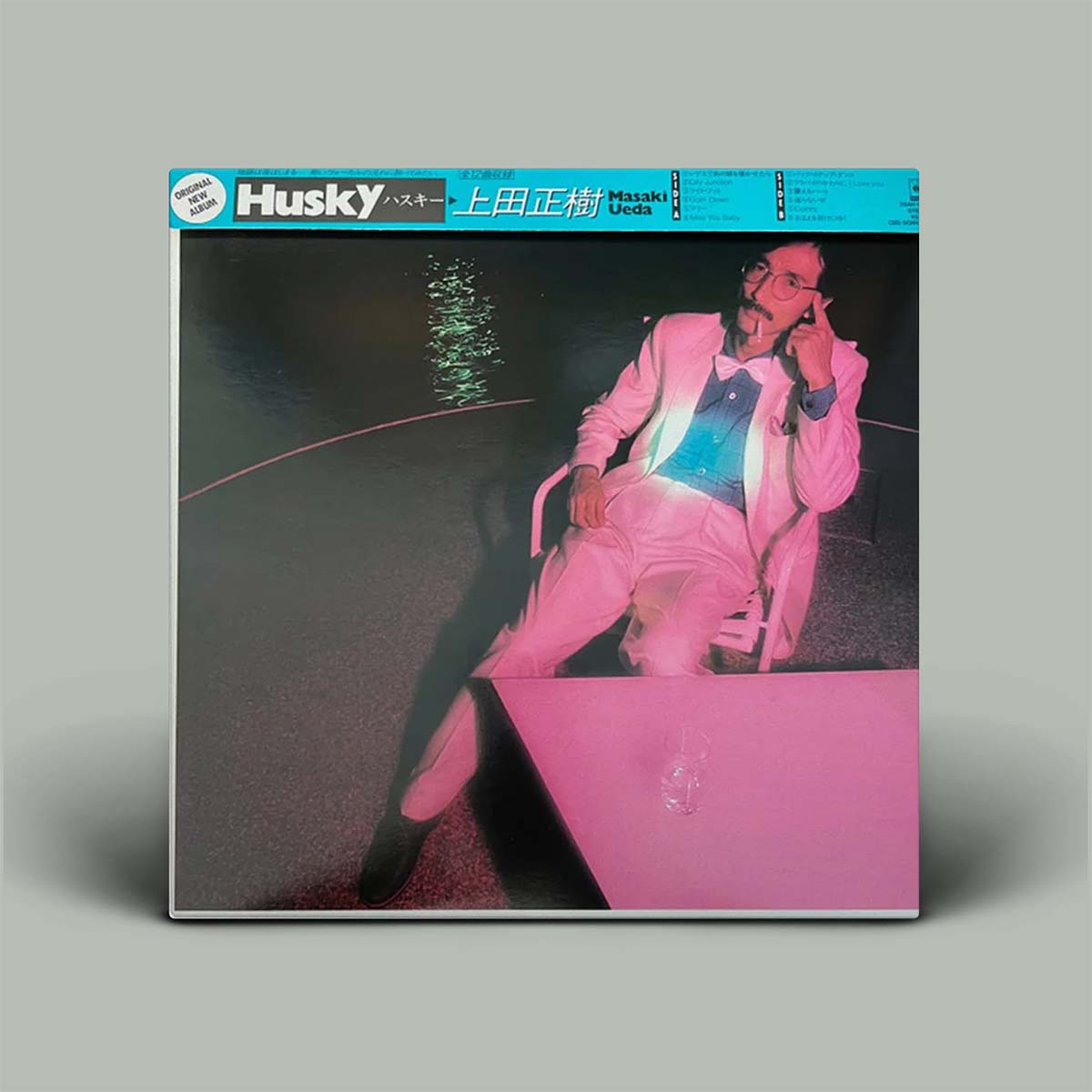 Vinyl record cover with a person in a pink outfit on a gray background