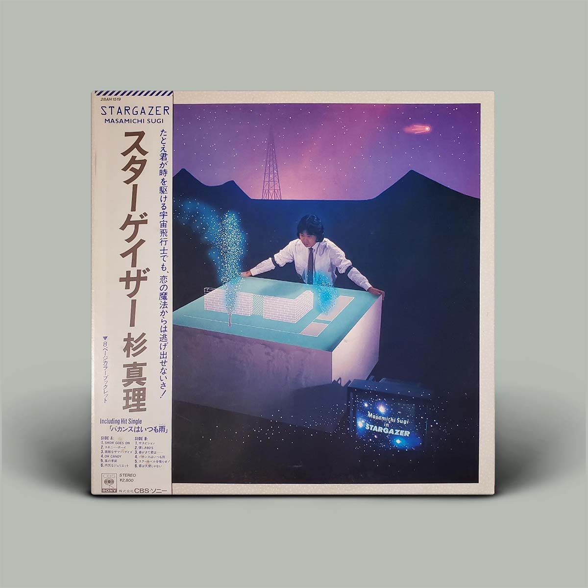Album cover for 'Stargazer' with a person interacting with a table displaying stars, set against a mountainous landscape.