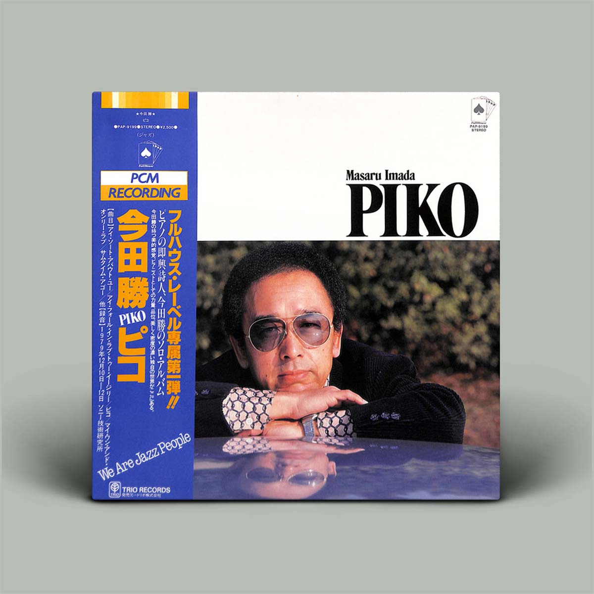 Album cover featuring a person with sunglasses and text on a gray background