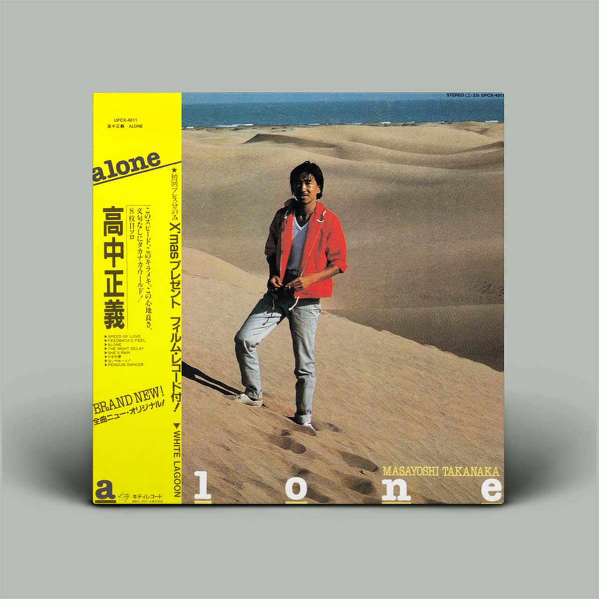 Album cover with a person standing in sand dunes and a yellow text block on the left.