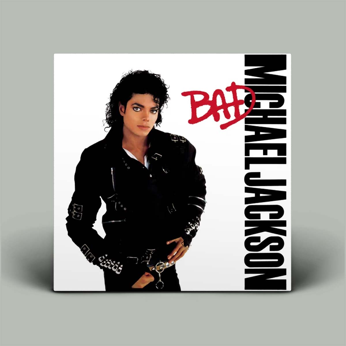 Michael Jackson 'Bad' album cover displayed as a physical product mockup against a neutral gray background.