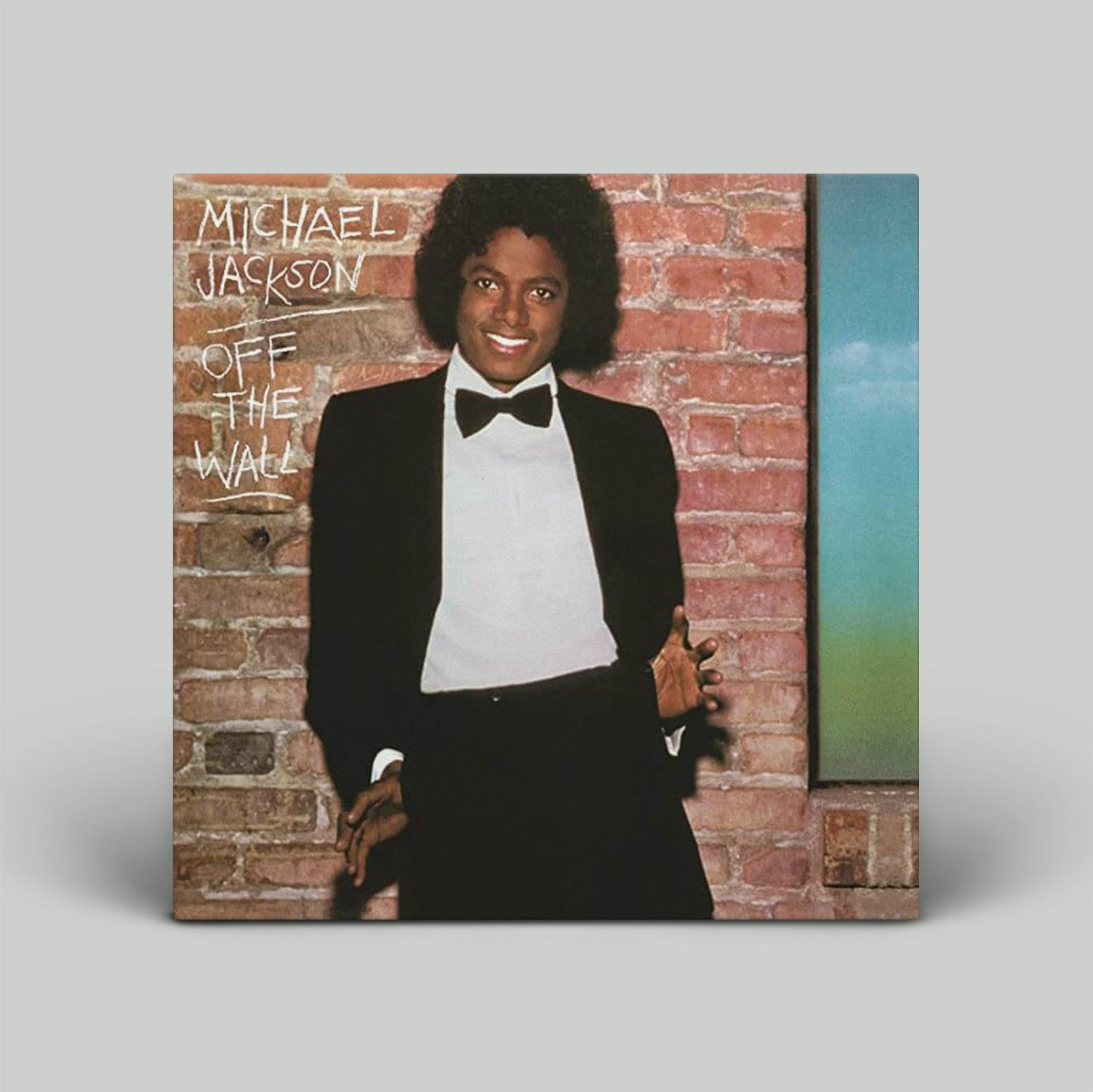 Vinyl record cover featuring Michael Jackson with text 'Michael Jackson Off The Wall' against a brick wall.