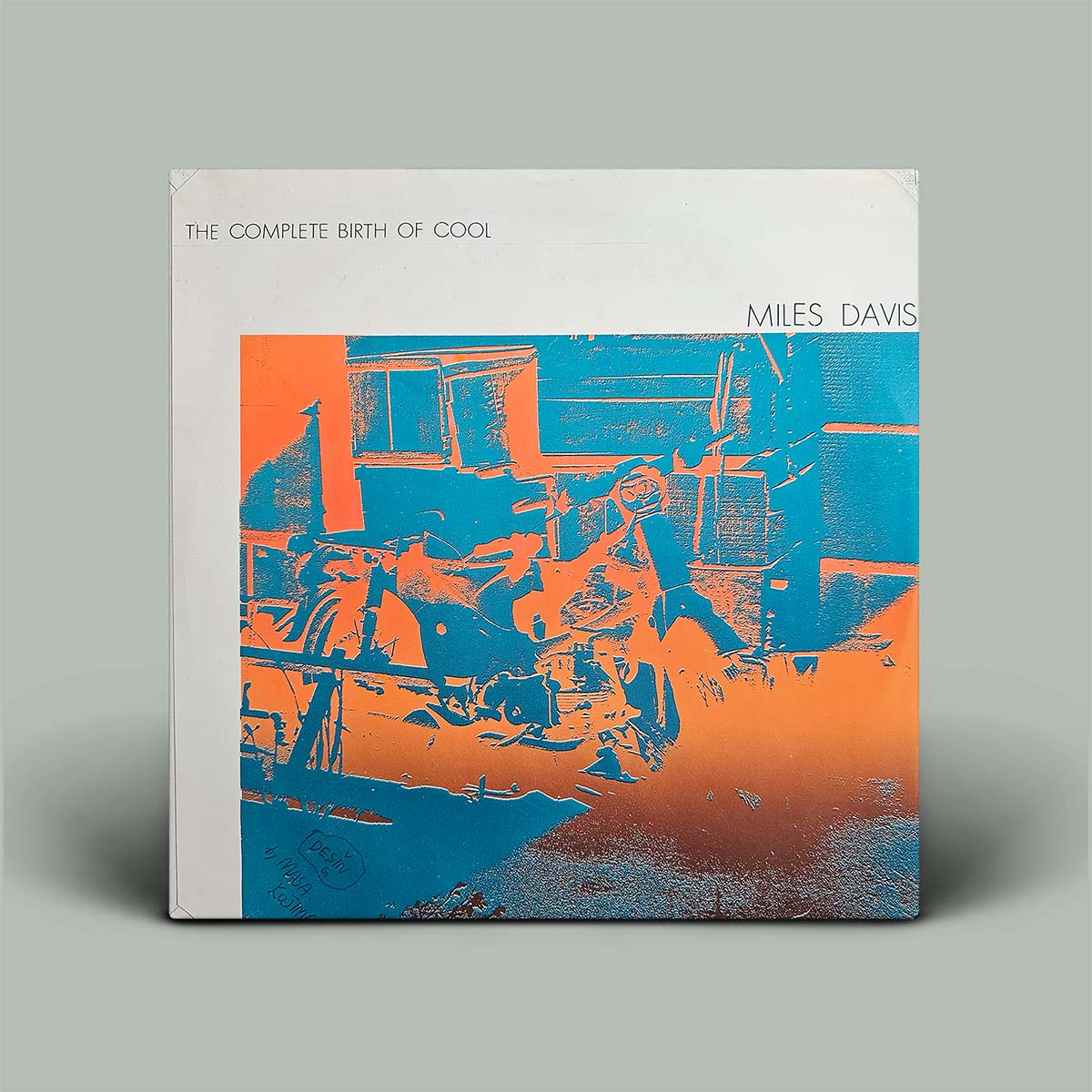 Album cover of 'The Complete Birth of Cool' by Miles Davis with abstract design in blue and orange on a gray background.