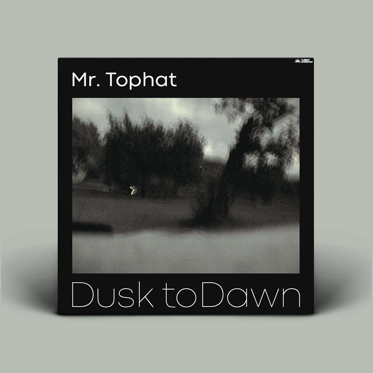 Album cover for 'Dusk to Dawn' by Mr. Tophat with black border and black and white landscape.