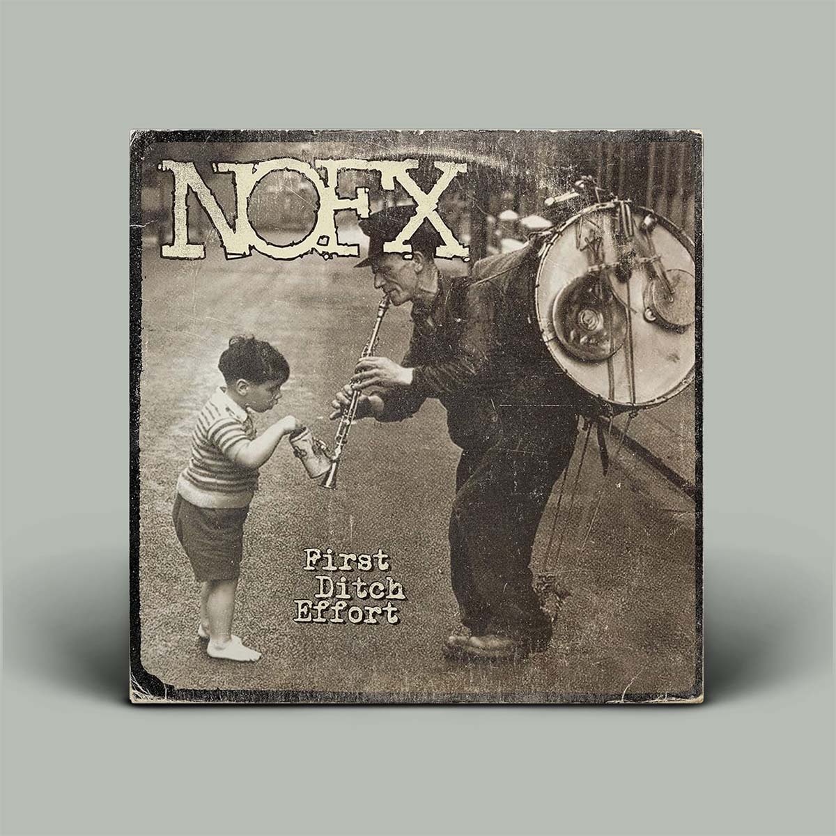 Album cover for NOFX's 'First Ditch Effort' featuring a man and child with musical instruments.