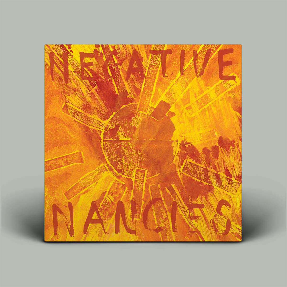 Album cover featuring a textured abstract design in vibrant orange, yellow, and red, with the words 'NEGATIVE NANCIES' written in a distressed red font, displayed on a neutral gray background.