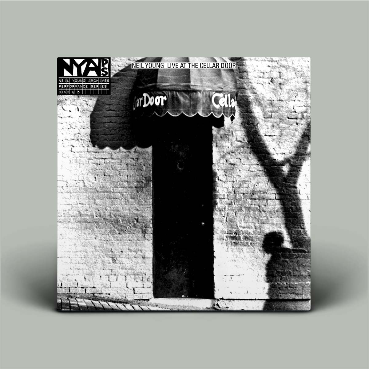 Vinyl record cover with black and white photo of a door and 'Cellar Door' text, featuring the NYAP logo.