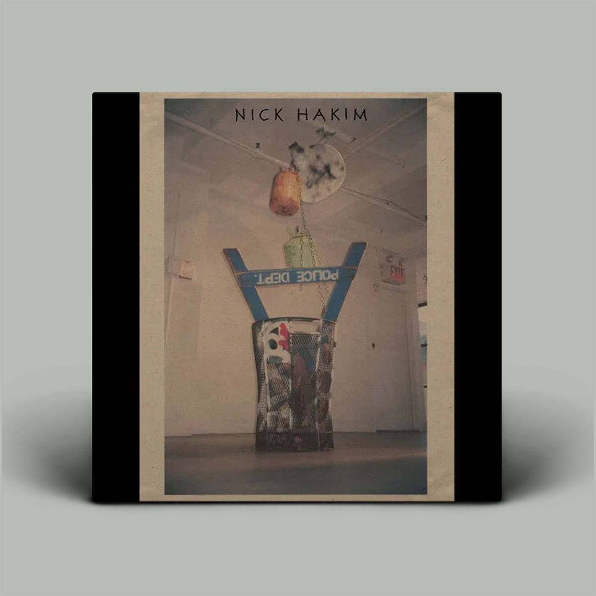 Book cover with a still life photograph and 'Nick Hakim' text on a gray background
