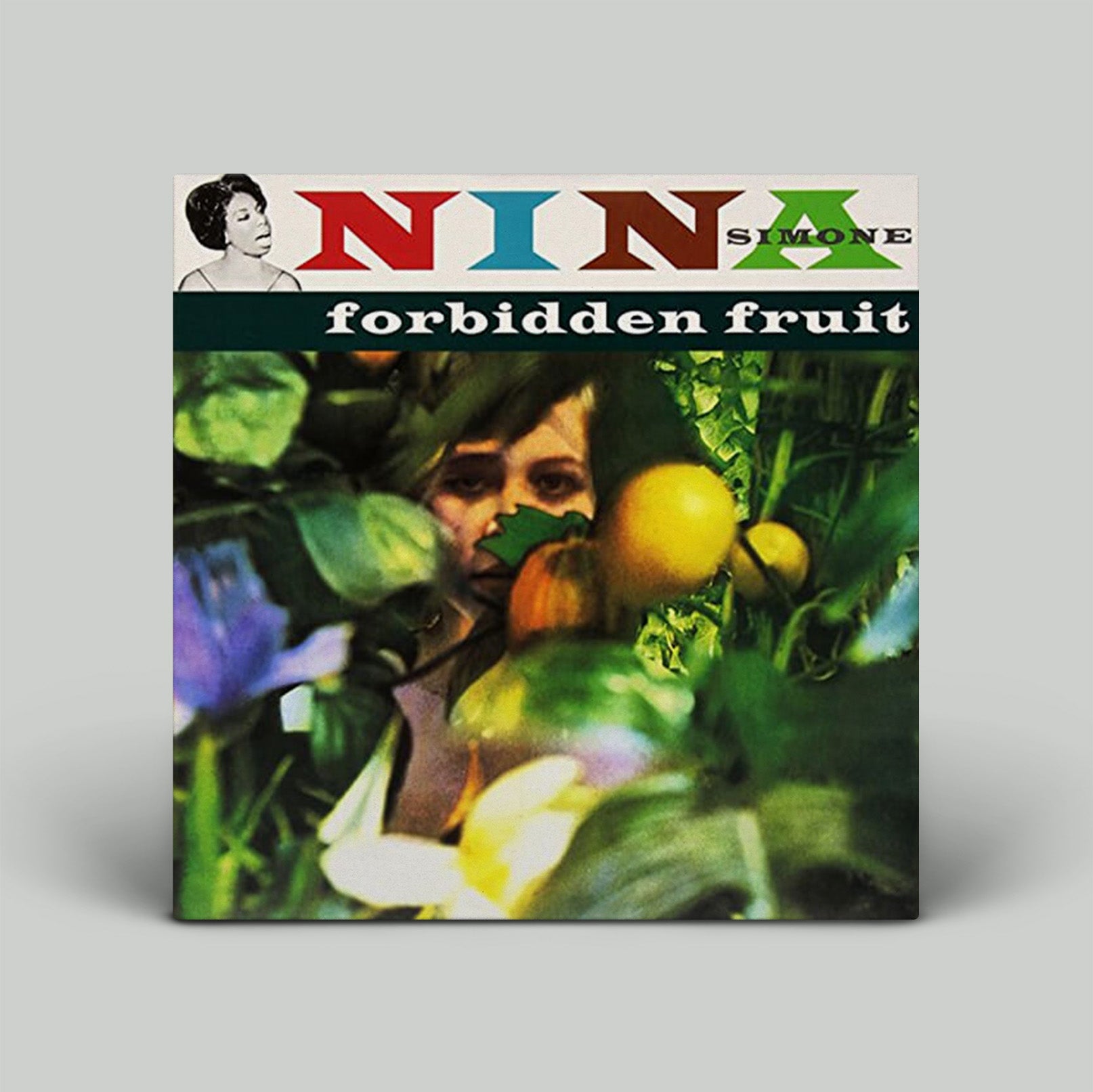 Vinyl record cover for 'Forbidden Fruit' by Nina Simone with a woman's face surrounded by fruits and vegetables.