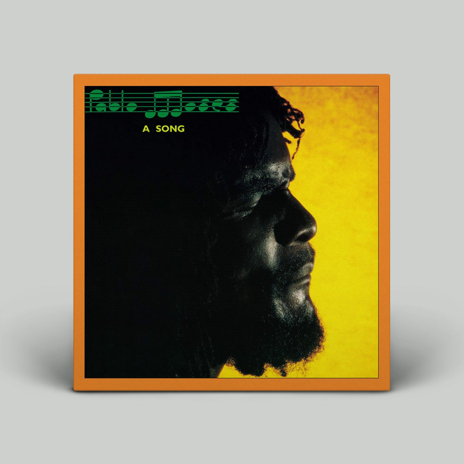 Album cover with a silhouette of a man's face on a yellow background with musical notes and text.