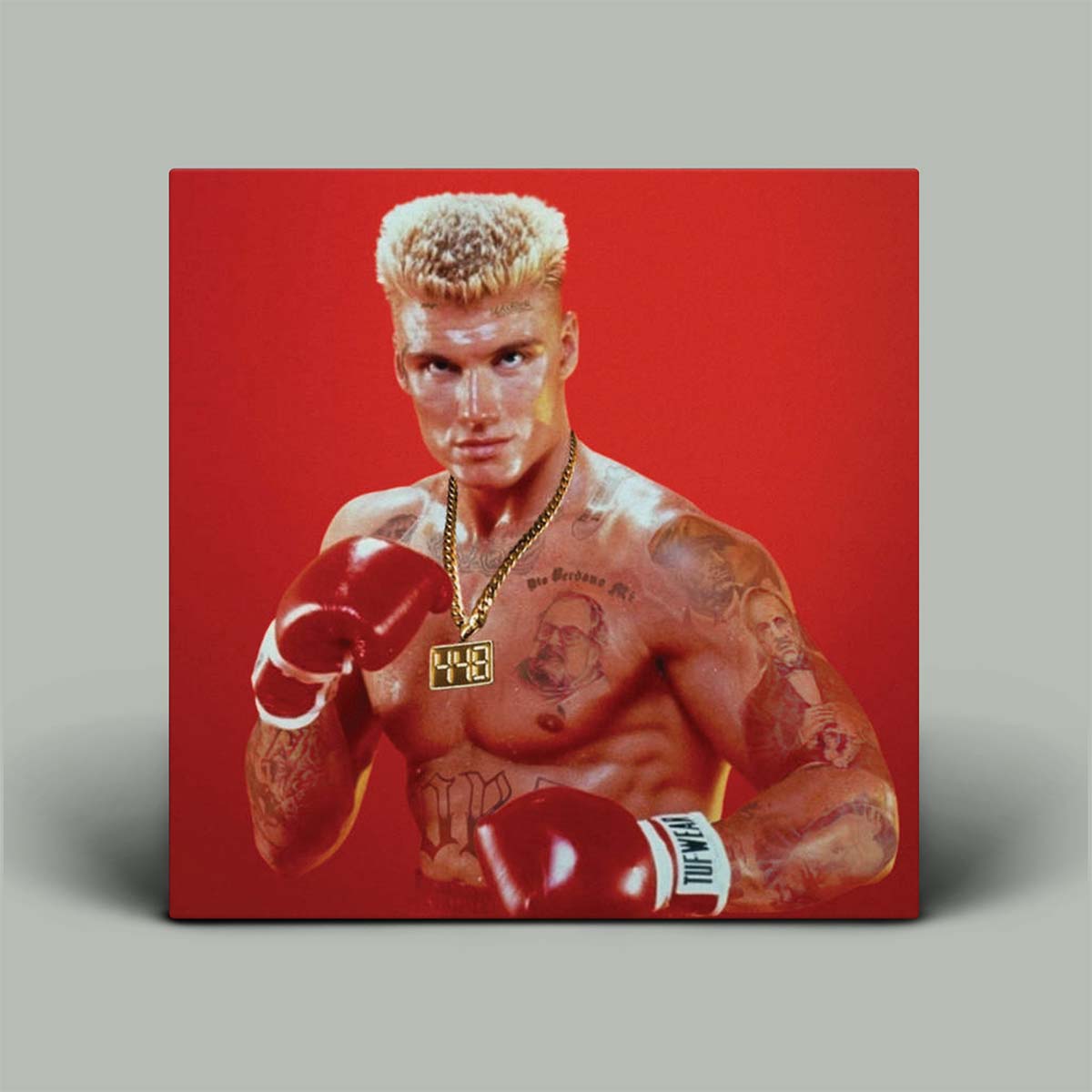 Album cover featuring a portrait of boxer Ivan Drago against a solid red background, shown as a physical canvas mockup on a neutral gray background.