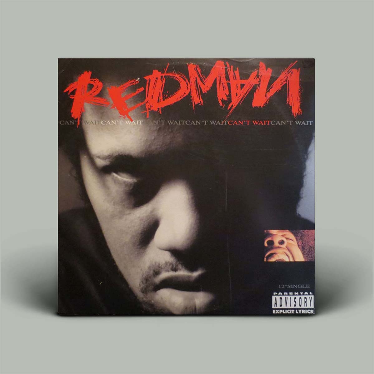 A vinyl record album cover for Redman's 'Can't Wait' single, displayed on a neutral gray background. The cover features a dramatic black-and-white close-up of the artist's face with a bold red textured 'REDMAN' logo at the top and a Parental Advisory label in the bottom right corner.