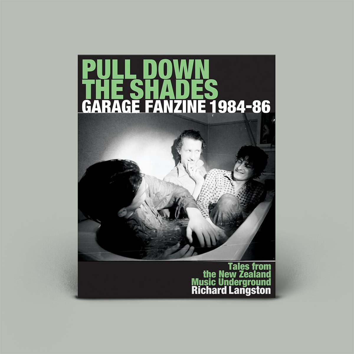 Photo of three men with green and white writing