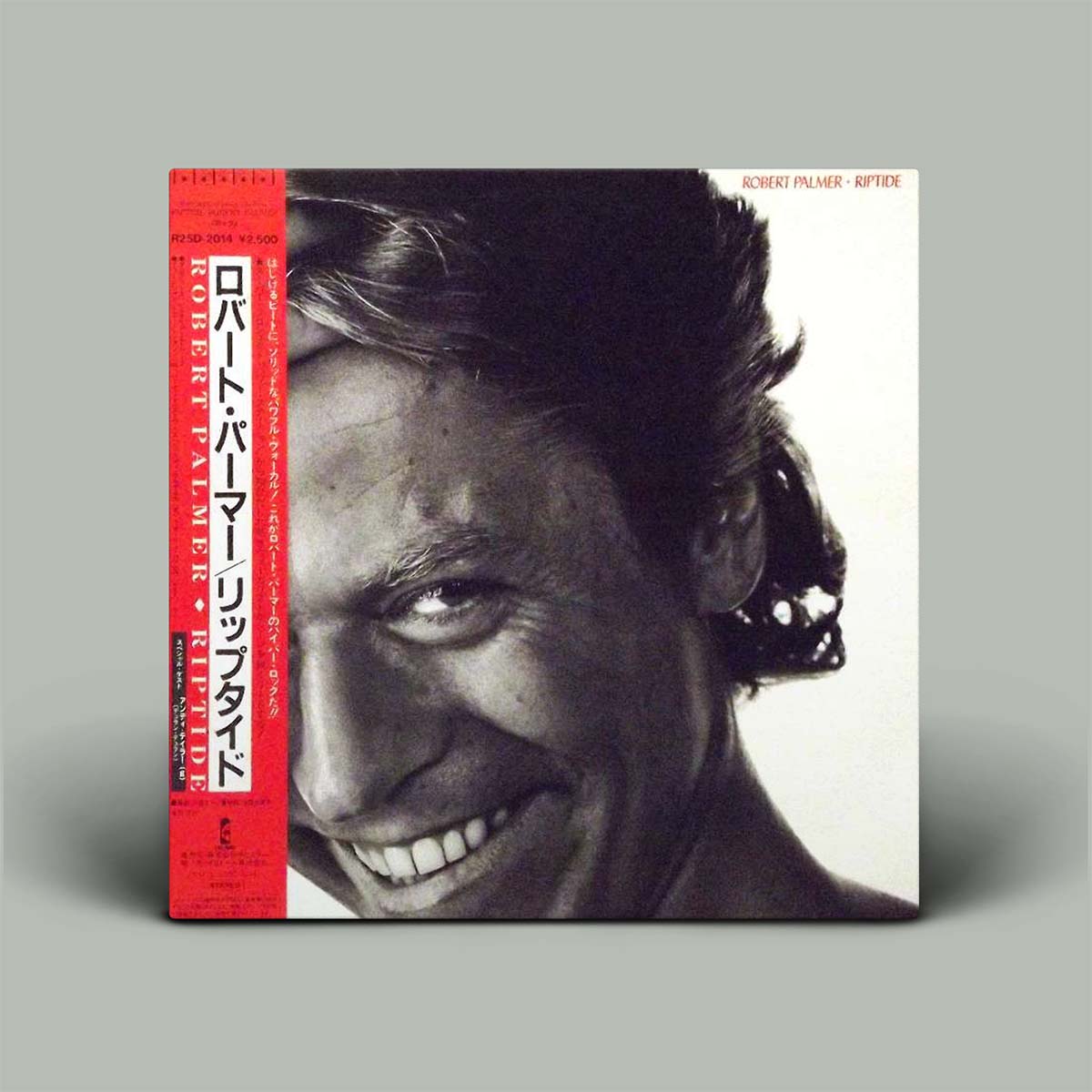 Japanese pressing vinyl record of Robert Palmer's album 'Riptide' with a black and white photo of Robert Palmer on the cover.