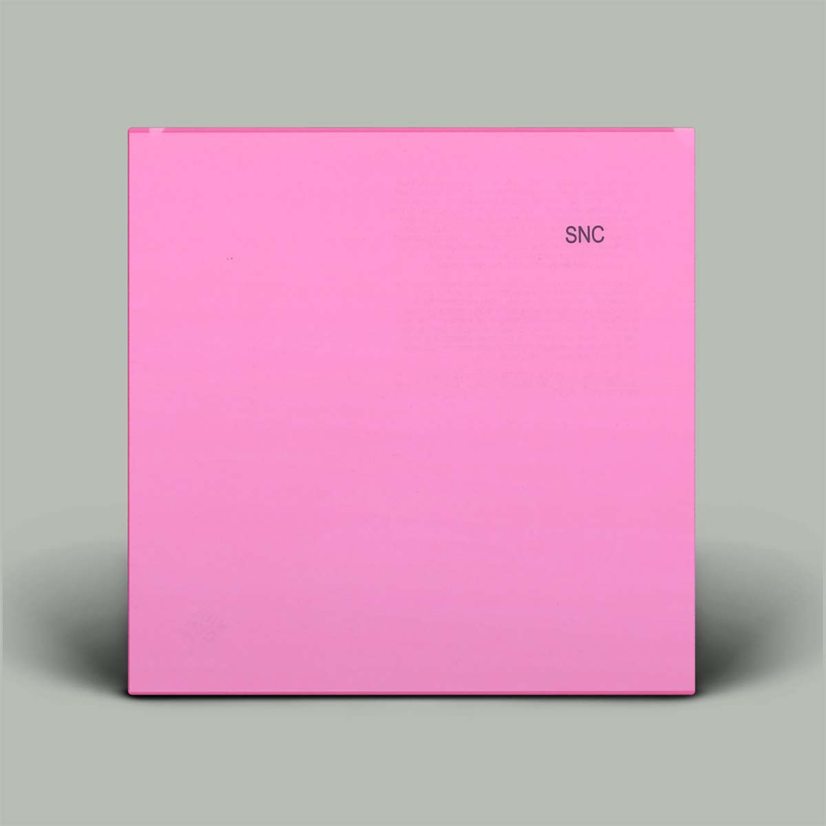 A square pink box with the letters 'SNC' printed in small dark text near the top right, shown against a light gray background.