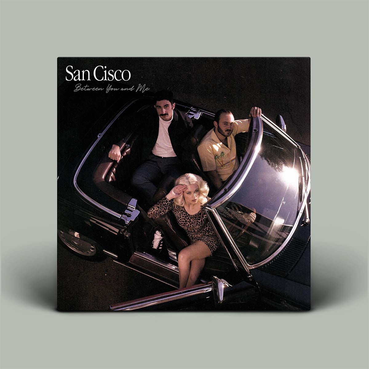 Album cover with aerial photo of band in convertible car.