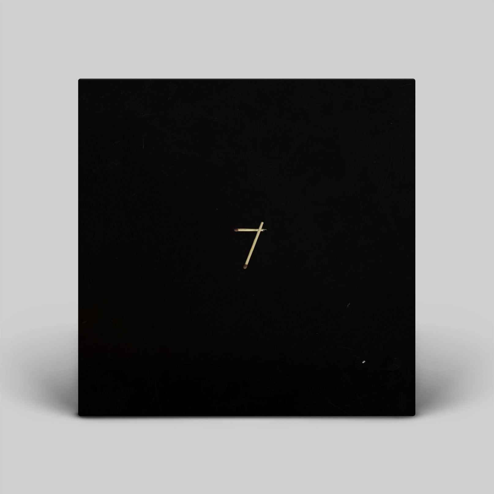 Black square with a gold number '7' on a gray background