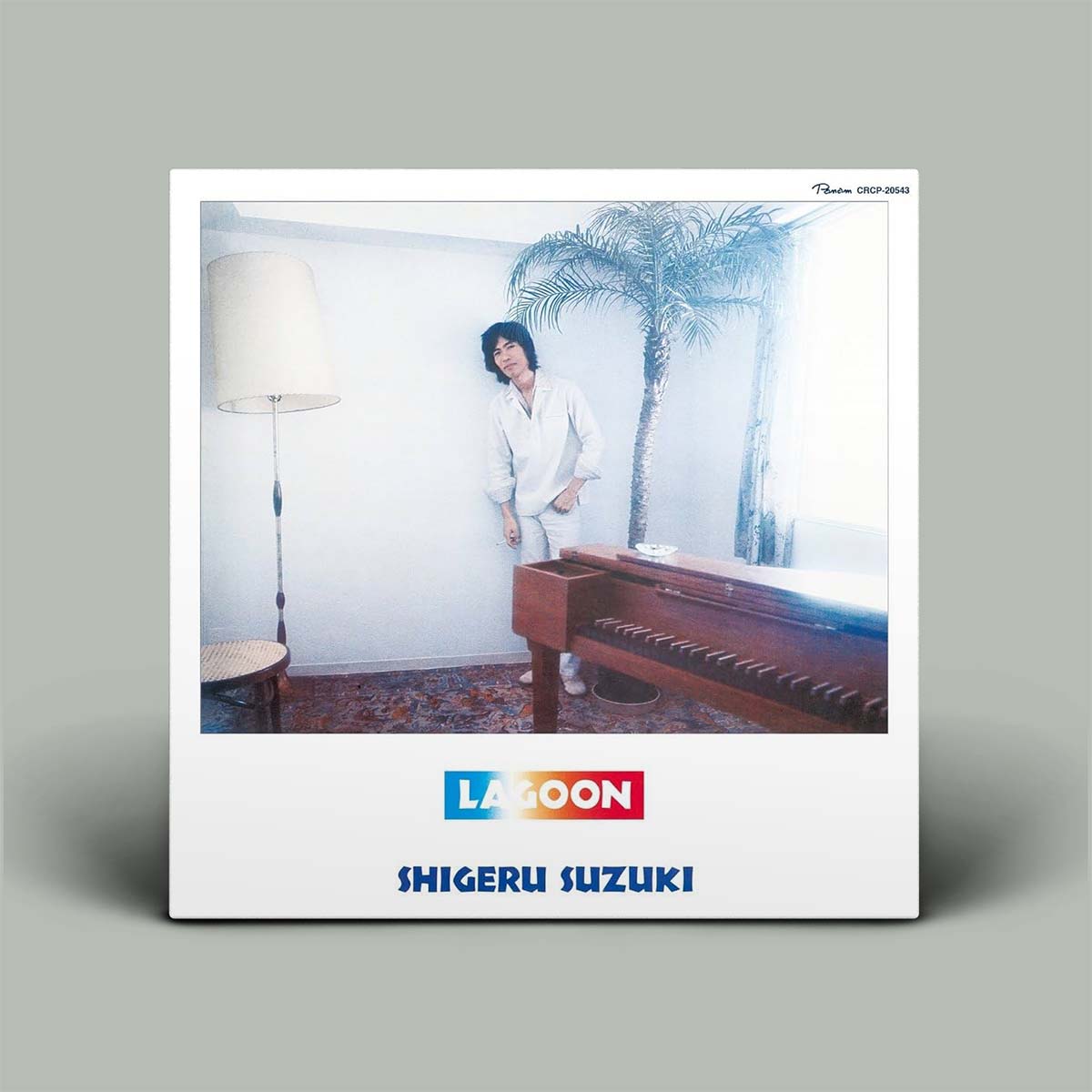Album cover with a person by a piano, palm tree, and Lagoon branding.