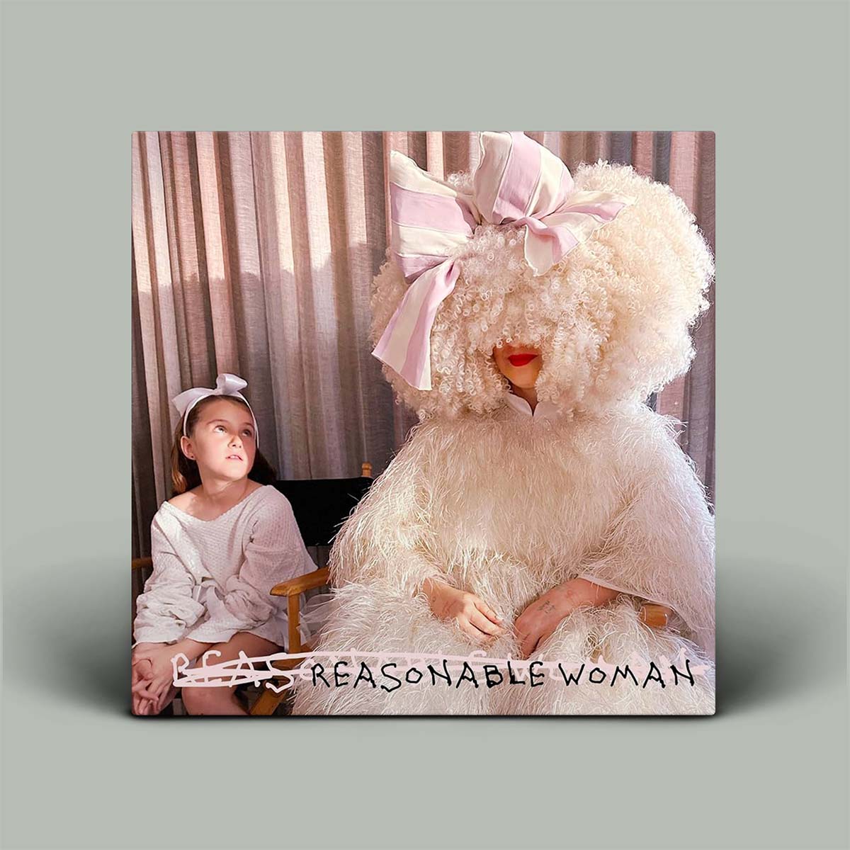 Album cover showing photograph of young girl sitting next to someone in a costume.