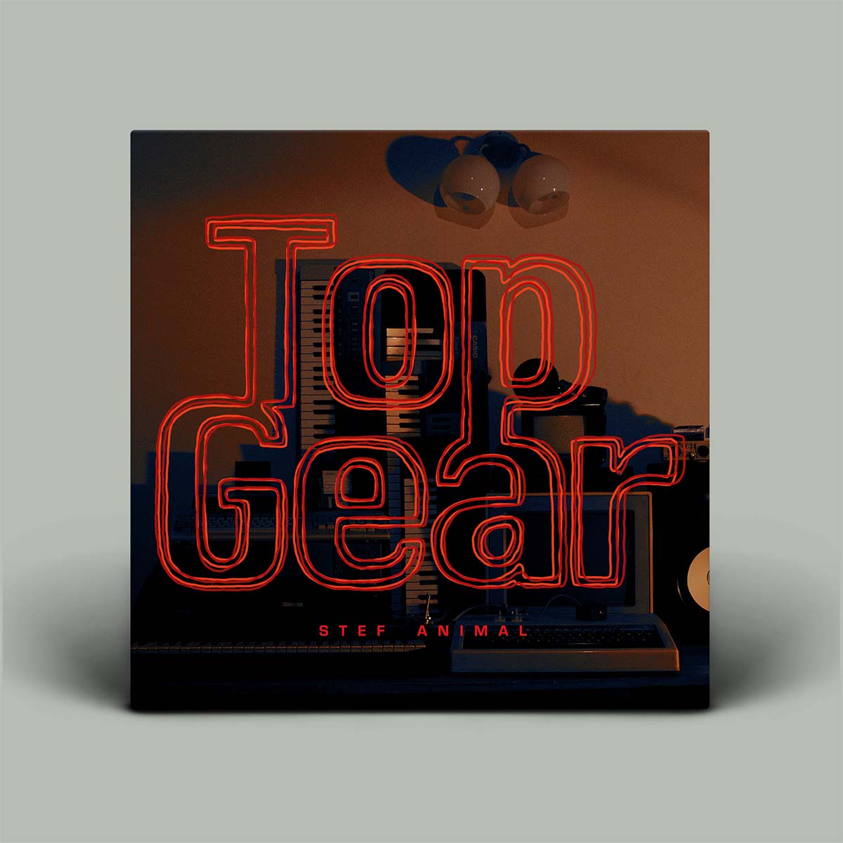 Album cover with the title 'Top Gear' in large red neon-style lettering over a dark industrial scene, with 'STEF ANIMAL' below. The cover is shown standing against a light gray background with a soft shadow.