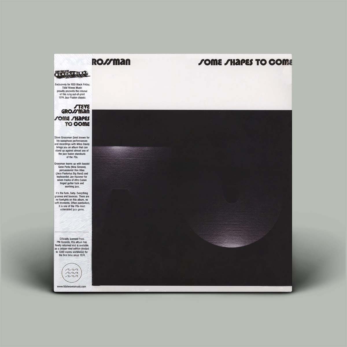 Vinyl record cover with text and a dark central area on a gray background