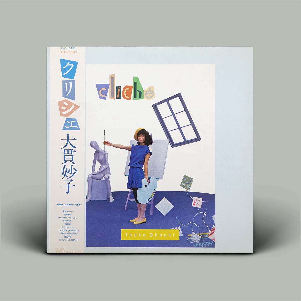 Album cover with a person in a room, colorful text, and geometric shapes on a gray background