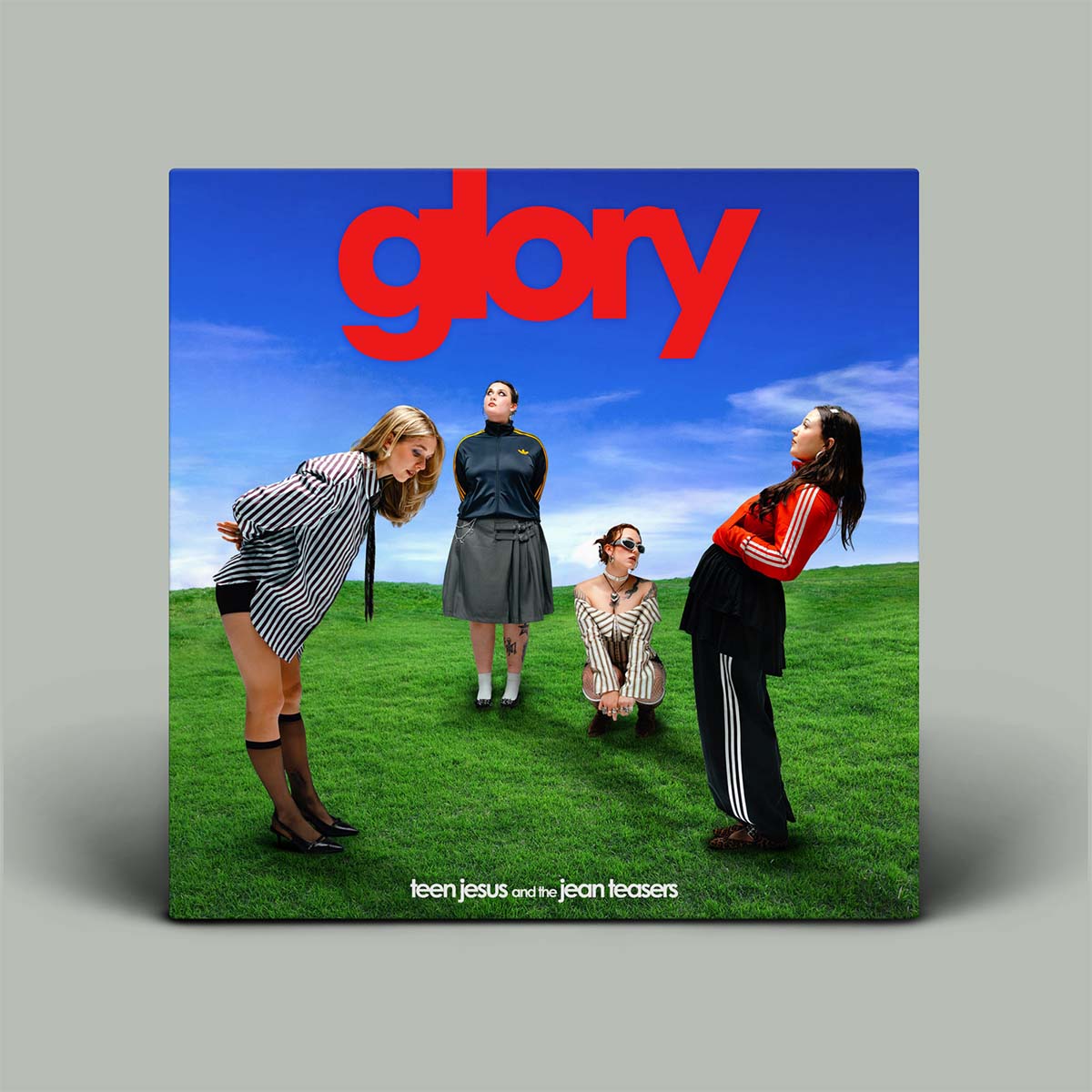 Album cover for 'glory' by Teen Jesus and the Jean Teasers with four people on a grassy field.