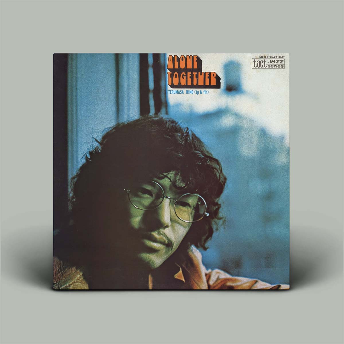 Album cover of 'Alone Together' with a person wearing glasses on a gray background