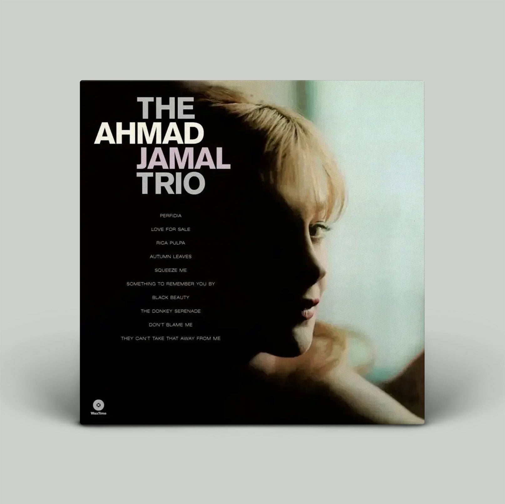 Album cover for The Ahmad Jamal Trio with a silhouette of a person and album tracklist.