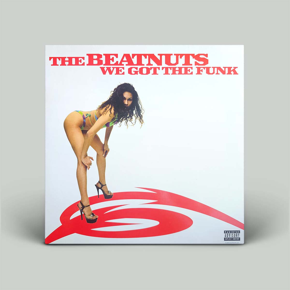 The Beatnuts 'We Got The Funk' vinyl record album cover displayed on a neutral gray background. The cover features a white background with bold red text at the top and a red graphic at the bottom, with a photo of a woman in a colorful bikini and black high heels in the center.