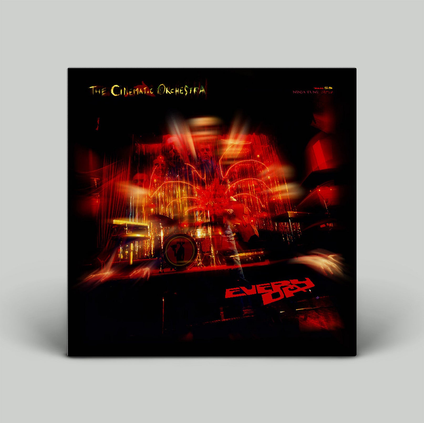 Vinyl record cover with a blurred image of a band performing and text on a black background