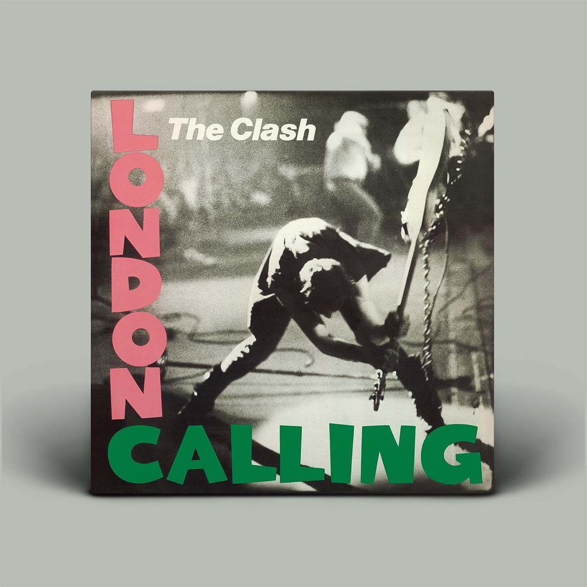 Black and white photo of person breaking guitar with LONDON CALLING written along the out side of the image.