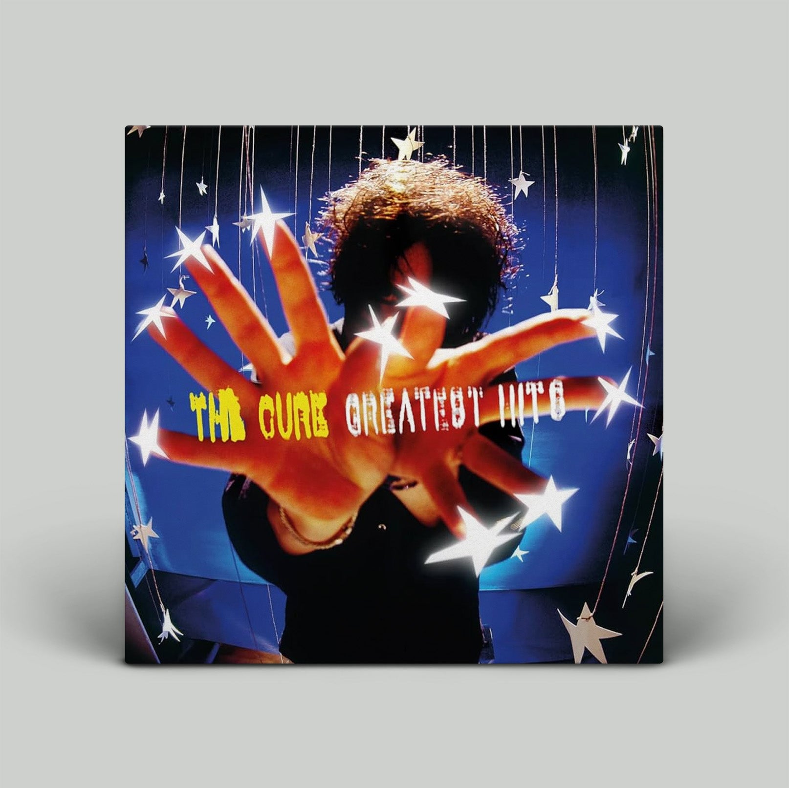 Album cover for 'The Cure Greatest Hits' with a hand and stars design.