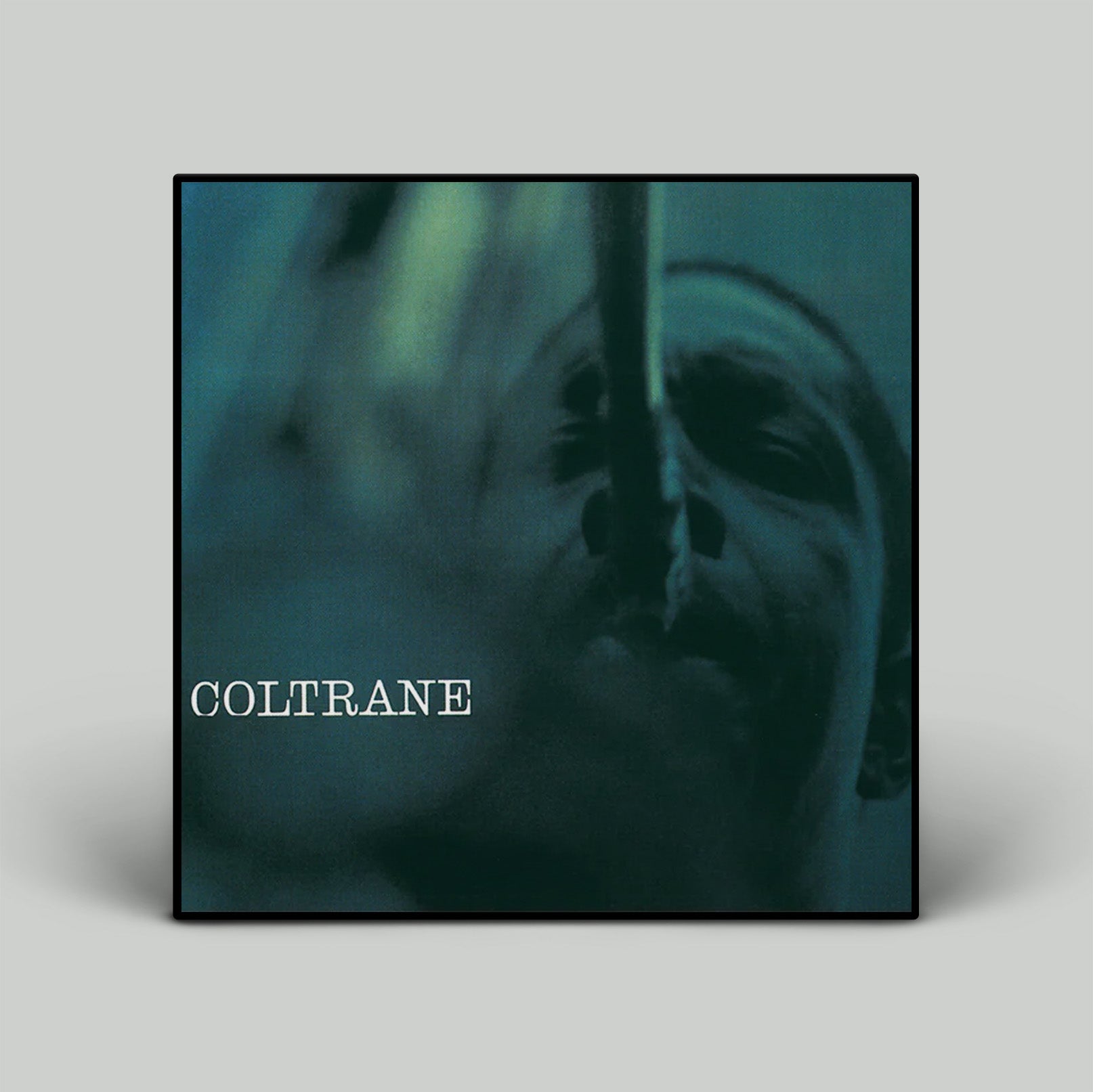 Album cover with a close-up of a person's face and the word 'COLTRANE' on a gray background