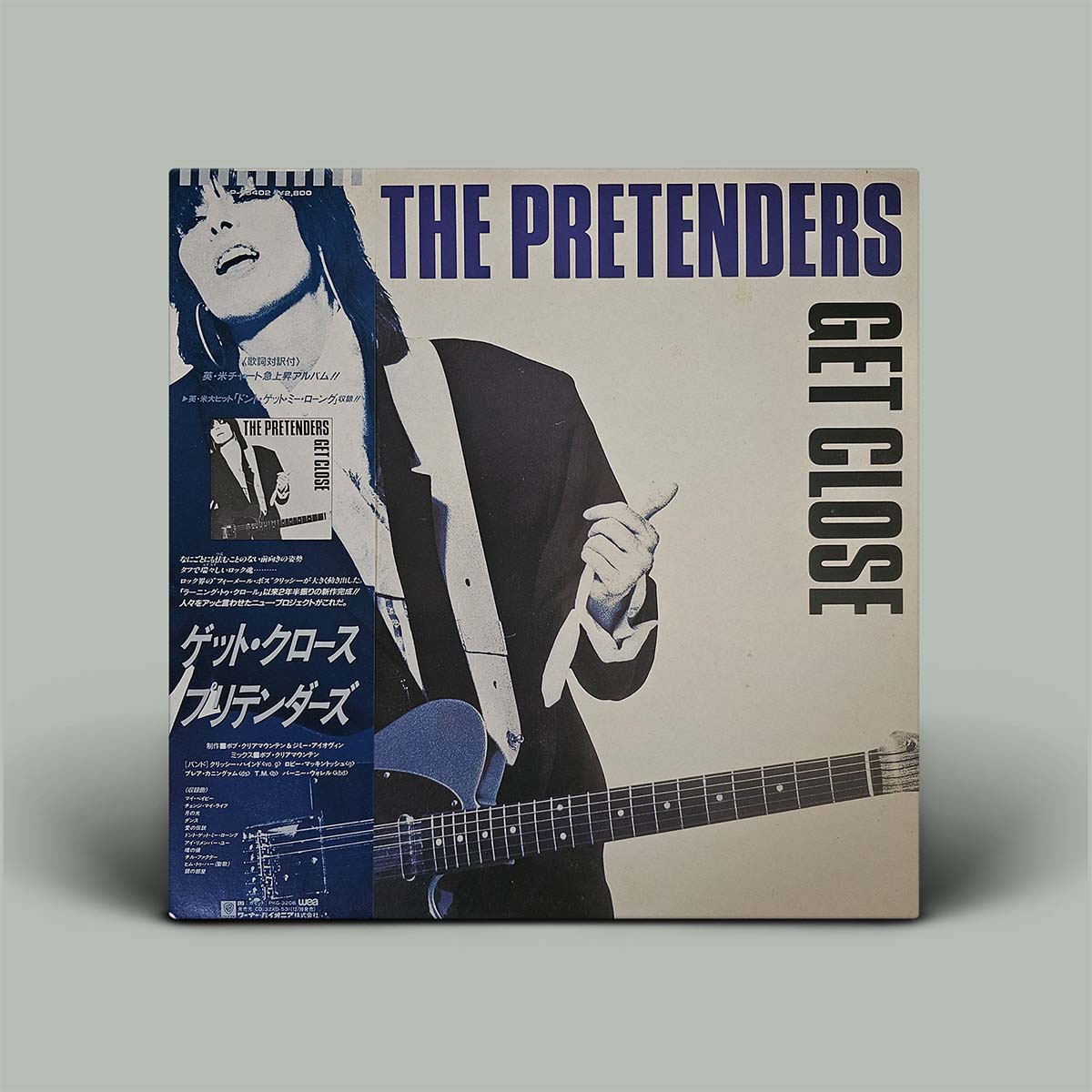 Album cover with photo of woman holding guitar and writing saying the pretenders get close