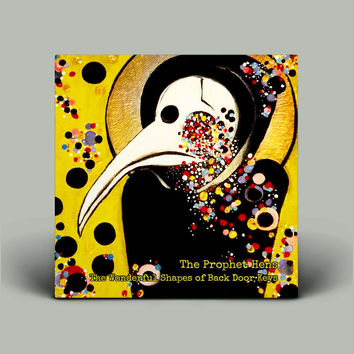 A square art print or book cover featuring a stylized black-and-white bird with a long beak on a bright yellow background with multicolored dots. The text at the bottom reads 'The Prophet Hens' and 'The Wonderful Shapes of Back Door Keys.