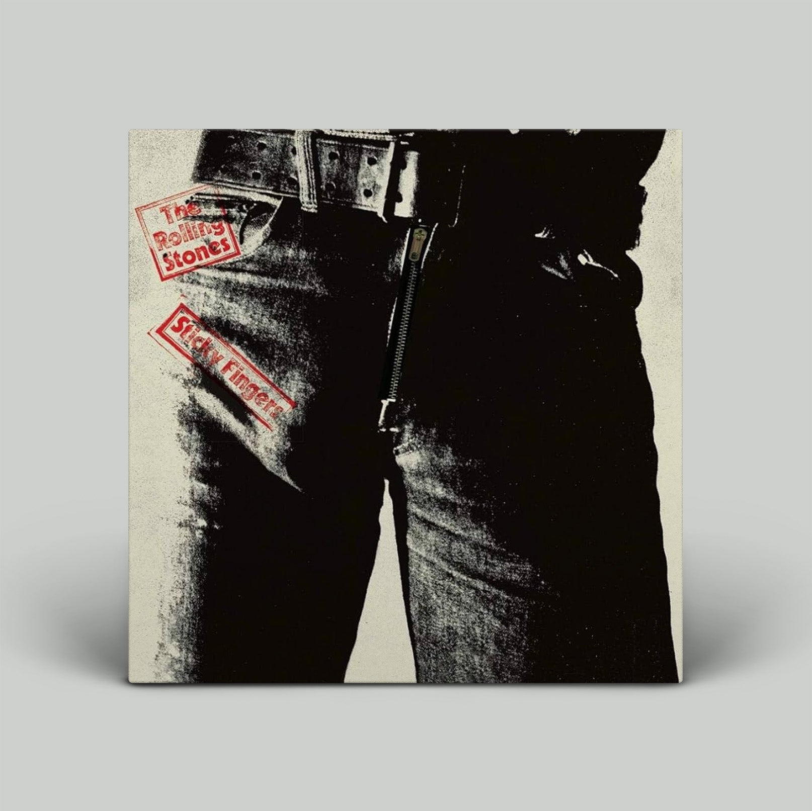 Album cover of 'The Rolling Stones' album with a person wearing jeans and a belt.