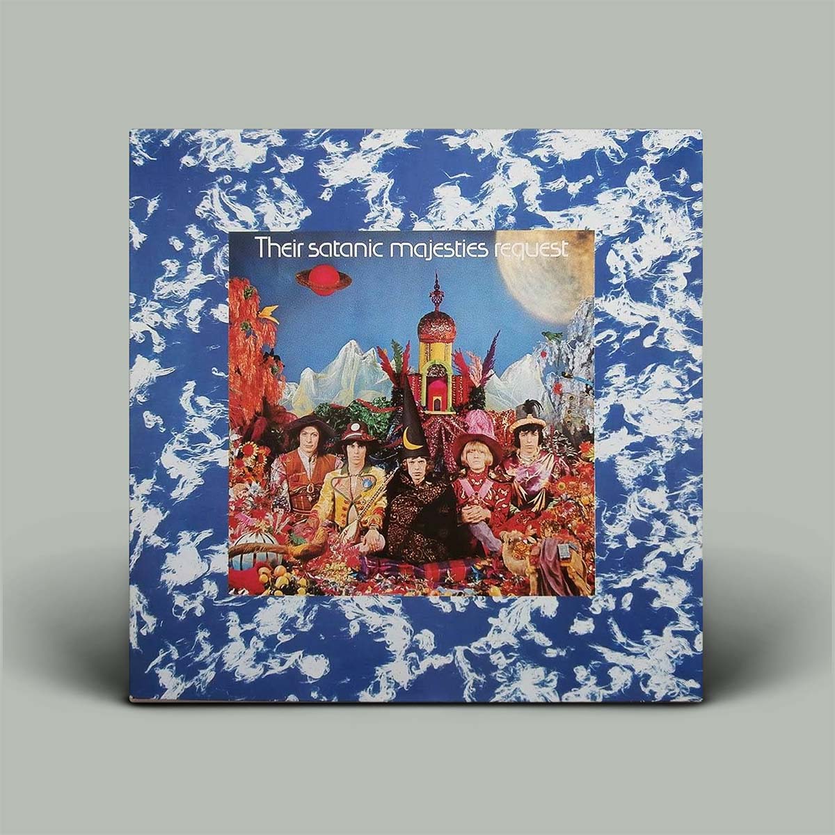 Album cover with a blue and white patterned border featuring a group of people in colorful attire.