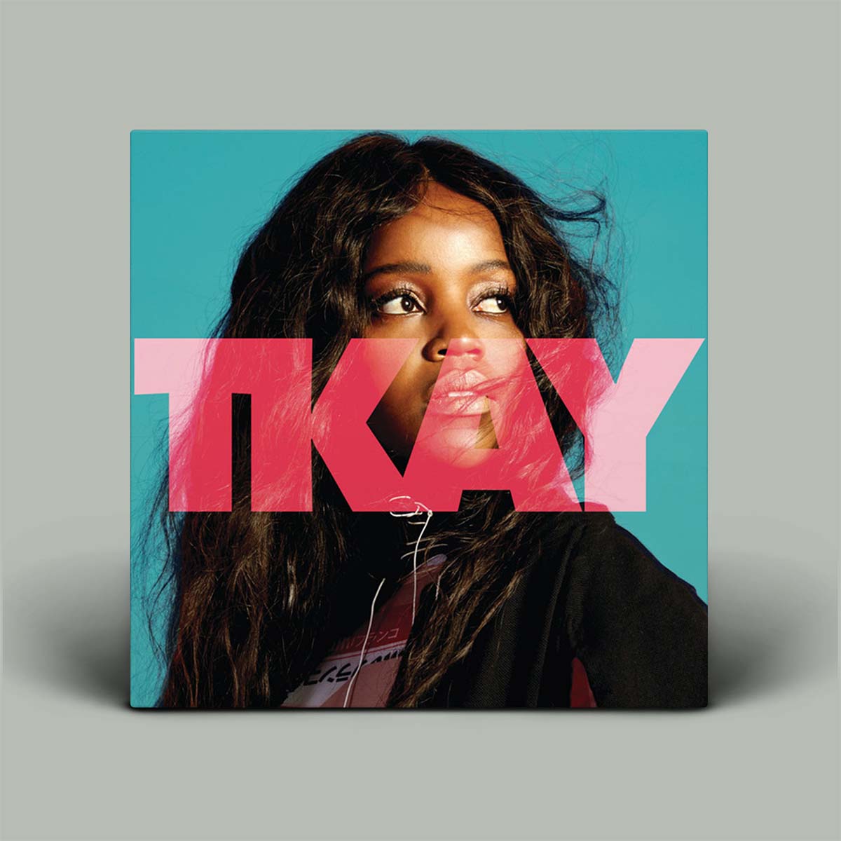 Album cover with a person and the word 'OKAY' in pink on a blue background